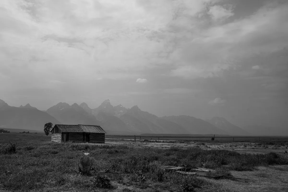 Weathered cabin alone in a mountain plain